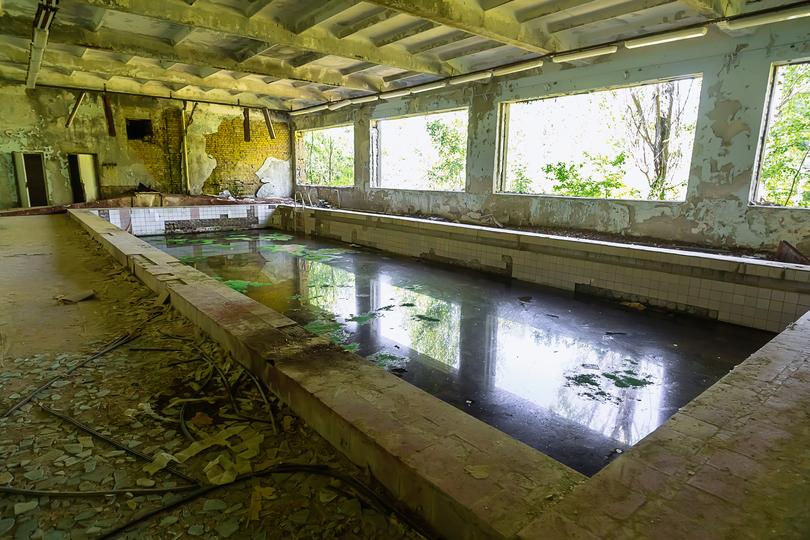 Pool removal contractor demolishing an inground pool