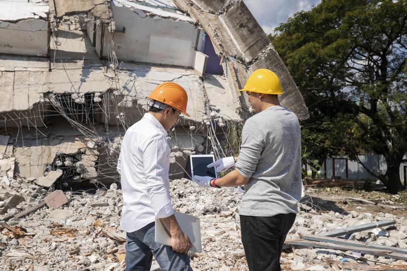 House being demolished by an excavator