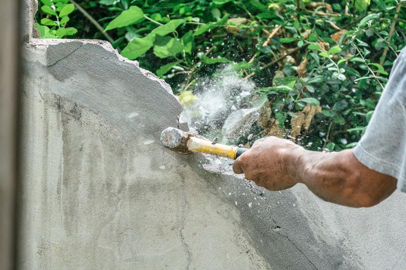 Demolition contractor demolishing a building