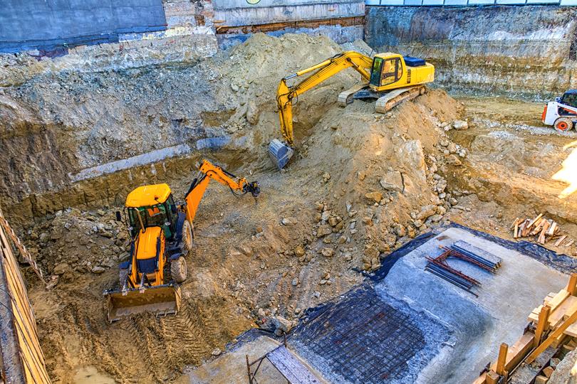 Excavation contractor operating an excavator on a construction site