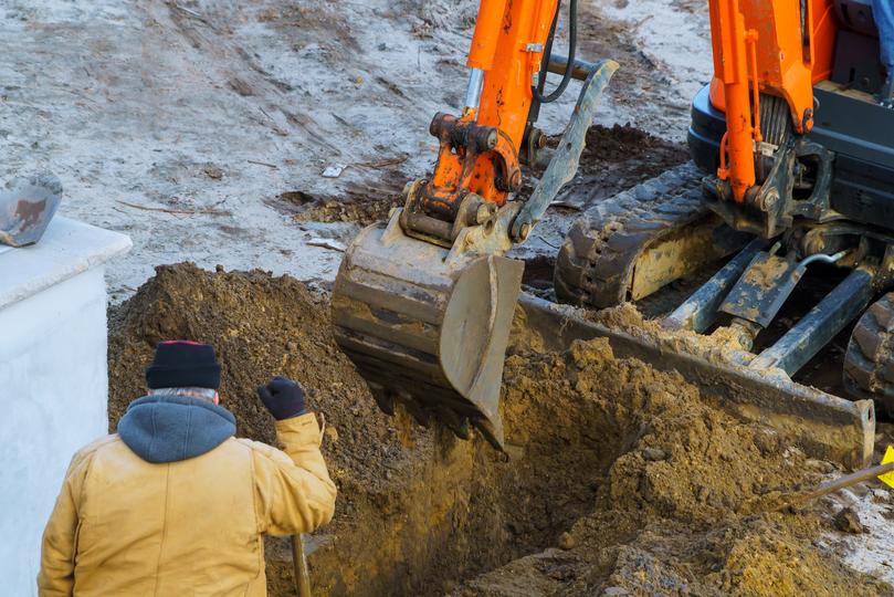 Excavation contractor operating an excavator on a construction site