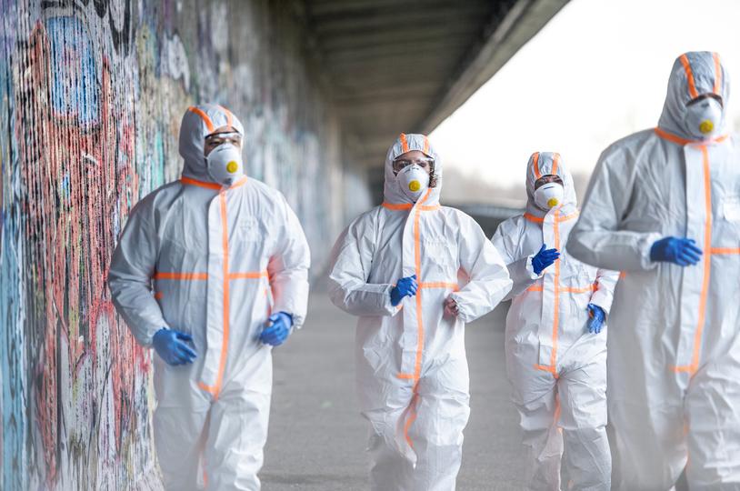 Workers in hazmat suits removing asbestos