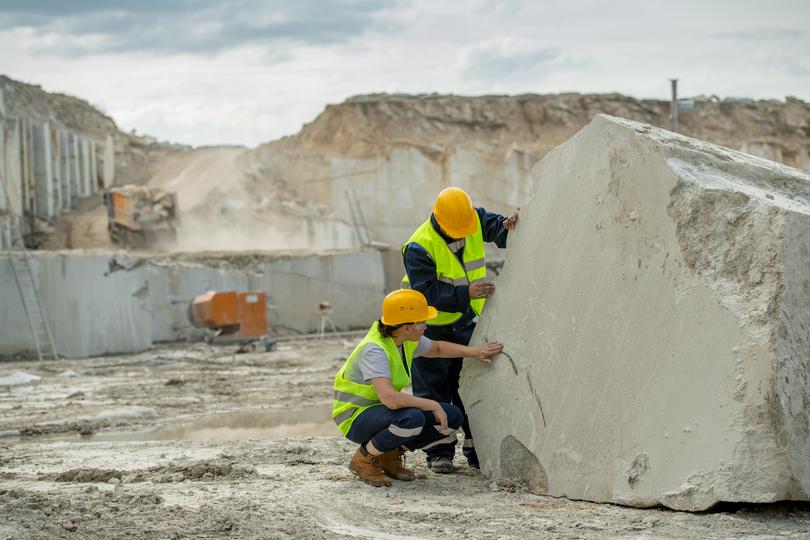 Worker operating a jackhammer for concrete demolition