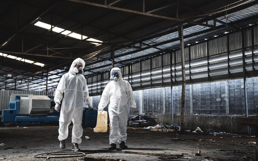 Workers in hazmat suits removing asbestos