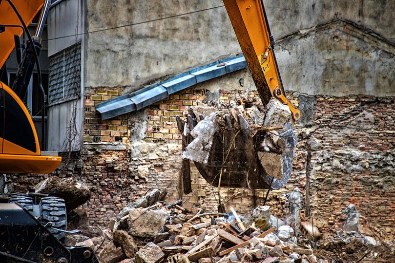 Demolition contractor safely demolishing a building